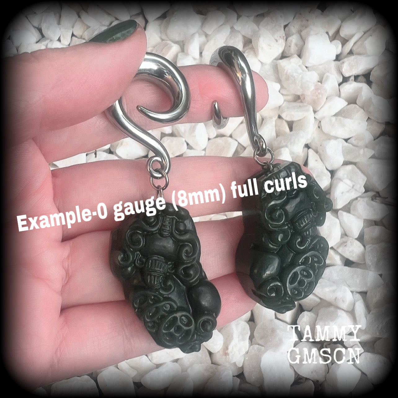 These gorgeous earrings are made from carved Lantian jade featuring the beautiful mythological lion dog, the Pi Xiu, weighing approx 34 grams a piece and measure just over 7cms from tip to tip.

This pair have been made with 0 gauge (8mm) surgical steel full curl hooks, to be worn in stretched lobes.