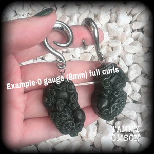 These gorgeous earrings are made from carved Lantian jade featuring the beautiful mythological lion dog, the Pi Xiu, weighing approx 34 grams a piece and measure just over 7cms from tip to tip.

This pair have been made with 0 gauge (8mm) surgical steel full curl hooks, to be worn in stretched lobes.