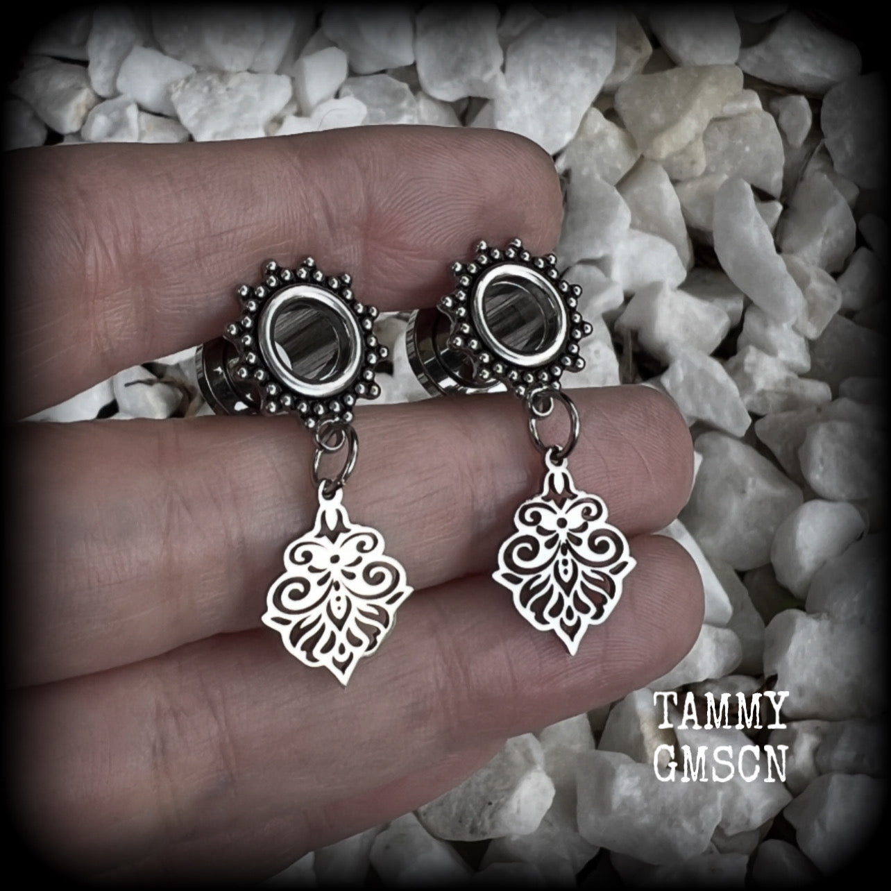 These beautiful ornate tunnel earrings feature gorgeous stainless steel filigree charms, inspired by Aphrodite, the Greek Goddess of love and beauty.

These earrings are nice and lightweight, weighing only a few grams each and measure just under 4cms from tip to tip.

This pair has been made with 0 gauge (8mm) gauge ornate surgical steel screw fit tunnels.