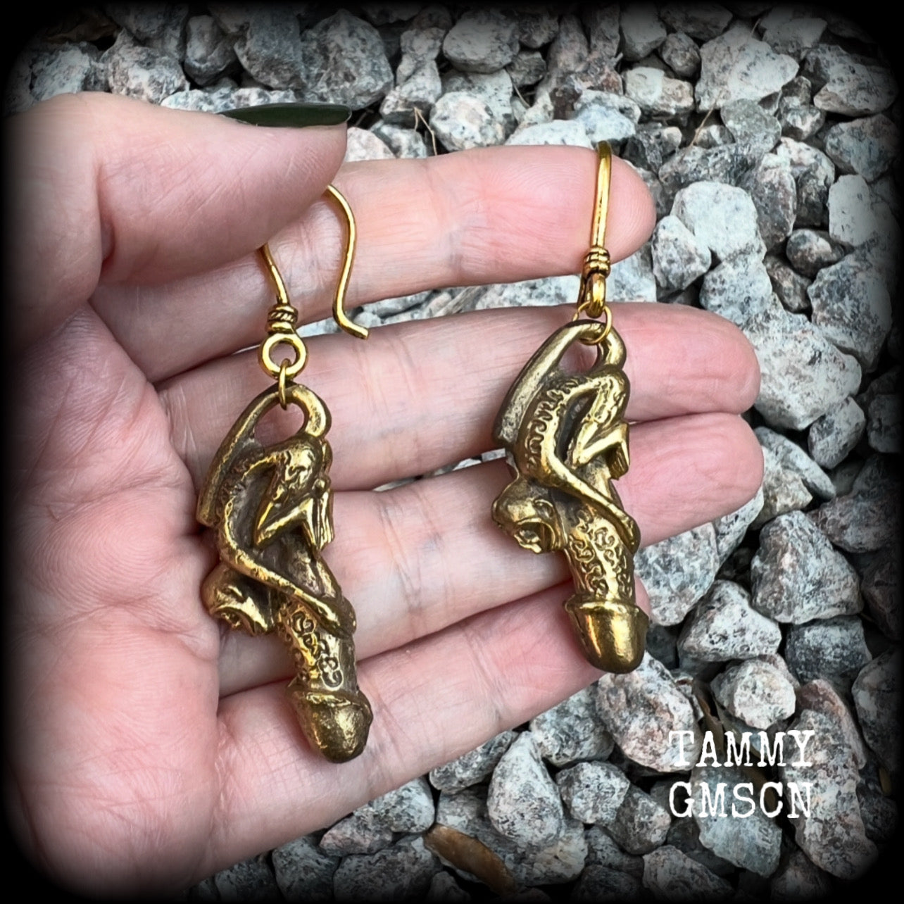 Featuring a brass Paladkhik penis charm, worn to attract love sex wealth and success and to protect from evil, these unique earrings weigh 19 grams each and measure just over 6cms from tip to tip.

This pair have been made on small antique antique gold shephard hooks, to be worn through stretched ears with silicone earlets from 8 gauge (3mm).