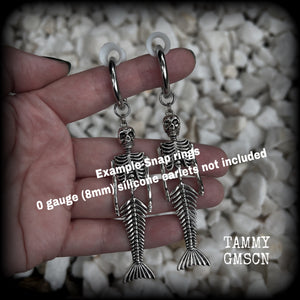 These gorgeous dangly earrings feature antique silver mermaid skeletons, measuring approx 10.5 cms from tip to tip, and weighing approx 14 grams a piece .

These earrings have been made on strong silver alloy snap hoop rings, to be worn in stretched lobes with silicone earlets from 2 gauge (6mm).