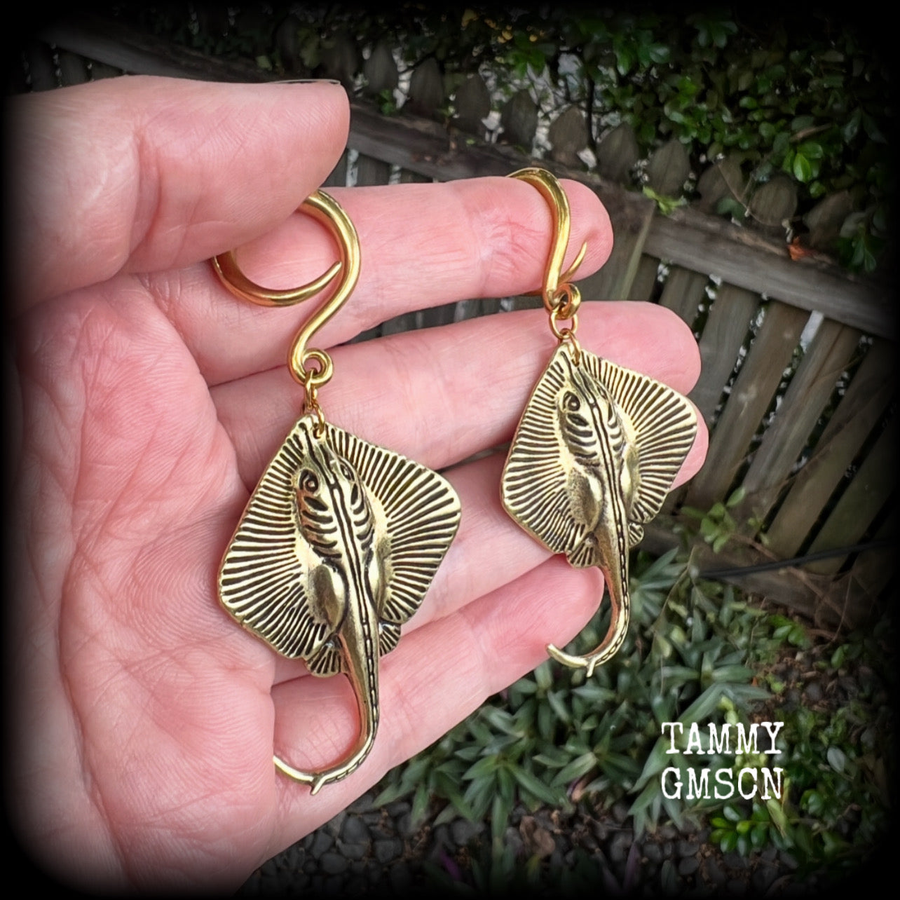 🔥 Symbolically, the stingray embodies calmness under pressure, self-defense, and navigating life's challenges with strength and balance.  

These awesome ear hangers feature a pair of brass sting rays, measuring just on 7cms from tip to tip, and weighing approx 17 grams each.

This pair has been made on 6 gauge (4mm) surgical steel full curls, suitable for stretched lobes.
