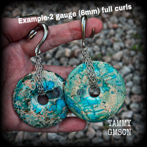 These ear weights feature gorgeous Turquoise ocean jasper donut gemstones cradled in antique silver chain, measuring just over 9cms from tip to tip, and weighing approx 40 grams each. 

This pair have been made on 2 gauge (6mm) surgical steel full curls, to be worn in stretched lobes.