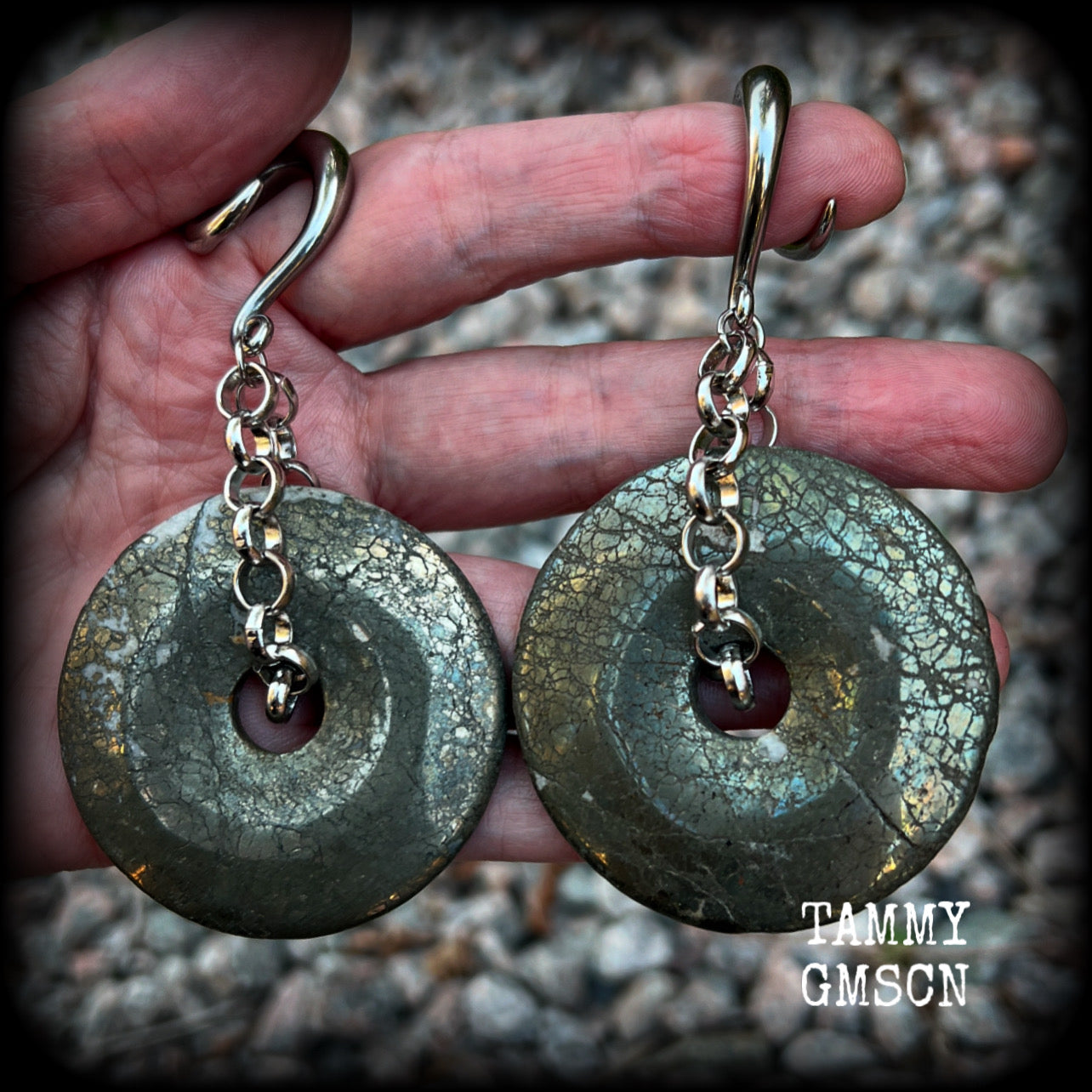 These beautiful big gauged earrings feature gorgeous Pyrite donut gemstones cradles in chunky antique silver chain, measuring just over 9cms from tip to tip, and weighing approx 55 grams each.

This pair has been made on 2 gauge (6mm) surgical steel full curls, to be worn in stretched lobes.
