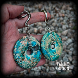 These ear weights feature gorgeous Turquoise ocean jasper donut gemstones cradled in antique silver chain, measuring just over 9cms from tip to tip, and weighing approx 40 grams each. 

This pair have been made on 2 gauge (6mm) surgical steel full curls, to be worn in stretched lobes.