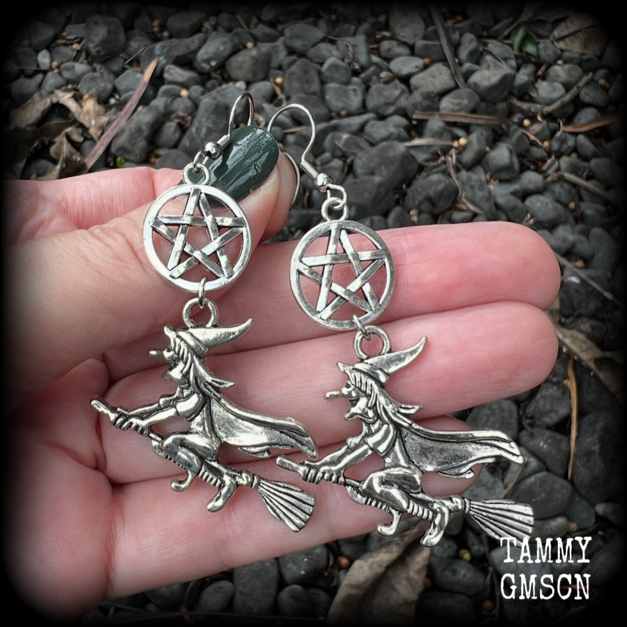 This pair of earrings feature a classic antique silver witch flying on her broomstick dangling from a silver pentagram, are nice and light weight at only 5 grams each, and nice and dangly, measuring just over 7cms from tip to tip.

This pair has been made on stainless steel french hooks, suitable for pierced ears.