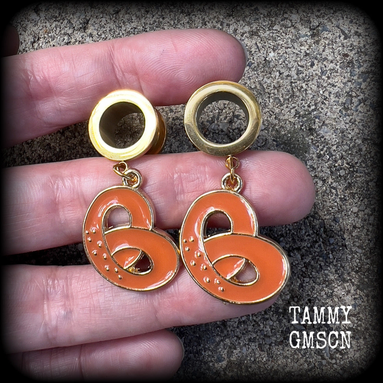 These adorable tunnel earrings feature classic enamel and antique gold pretzel charms, weighing approx 5 grams each, and measuring just over 4 cms from tip to tip.

This pair has been made with 1/2” gauge (12mm) surgical steel screw fit tunnels, to be worn in stretched lobes.