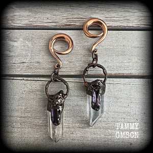 These clear quartz and amethyst gauged earrings are simply gorgeous!!
Featuring gorgeous amethyst stones sitting on front of chunky quartz pillars in an antique copper setting, these gauged earrings measure just on 9.5cms from tip to tip, and weigh approx 25 grams each.
This pair has been made on 6 gauge (4mm) surgical steel full curl hooks, suitable to be worn in stretched lobes.