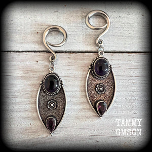 Featuring beautiful purple amethyst gemstones in a boho antique silver setting , this pair of earrings weighs approx 8 grams a piece and measure just under 8cms from tip to tip.

This pair have been made on 6 gauge (4mm) surgical steel full curl hooks, to be worn in stretched lobes.