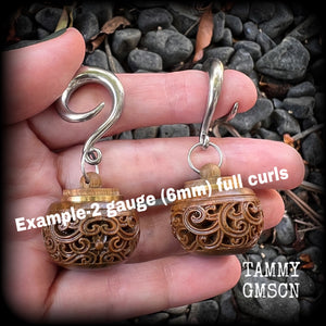 These beautifully carved Sandalwood stash pot earrings weigh in at only 15 grams a piece, and measure just on 6cms from tip to tip.
This pair has been made on 2 gauge (6mm) stainless steel full curled hooks, to be worn in stretched lobes.