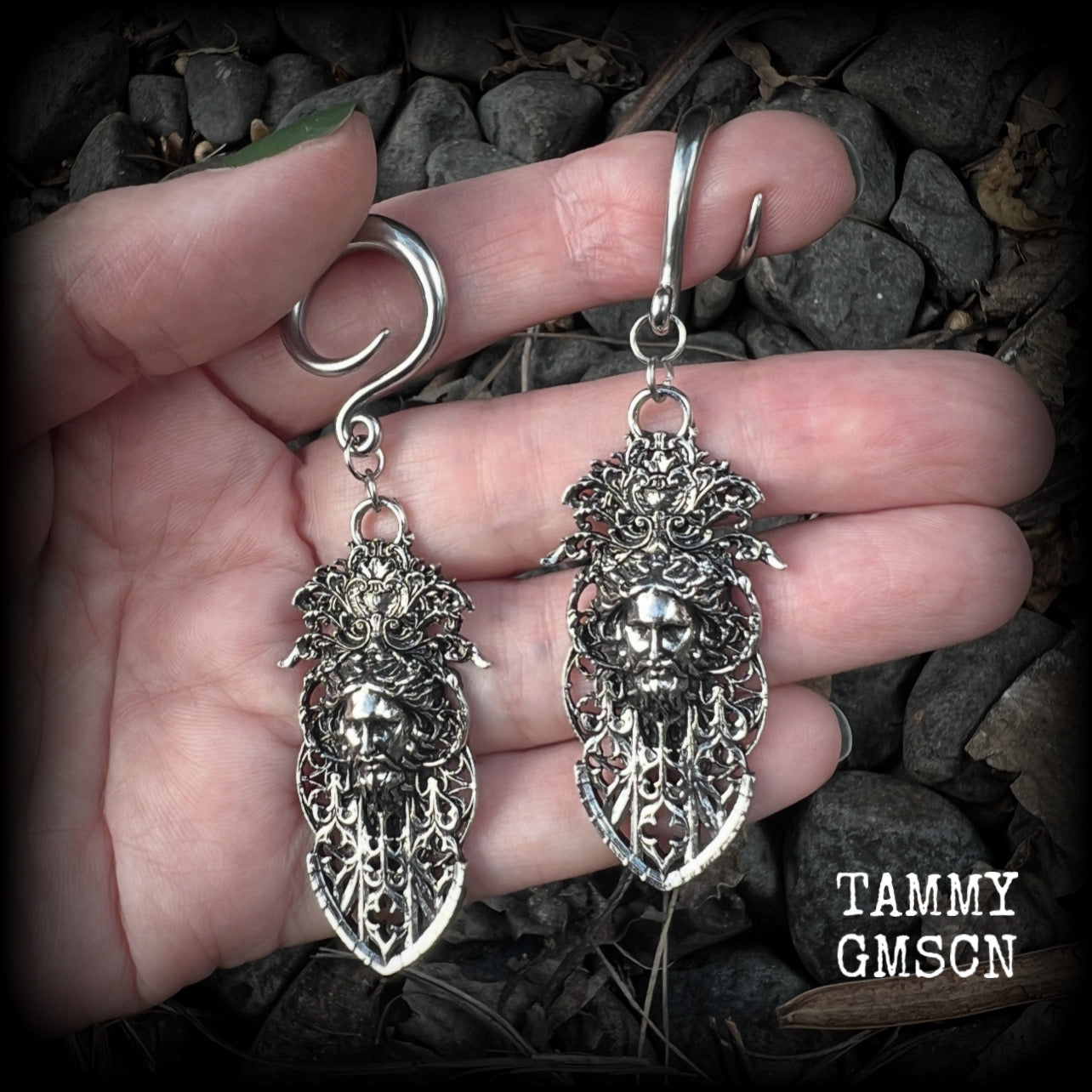 These gorgeous gothic antique silver gauged earrings feature beautiful baroque architecture with the face of Zeus-strong, commanding and masculine, depicted with flowing hair and moustache.

These earrings measure just on 8cms from tip to tip, and weighing approx 15 grams each.

This pair has been made on 6 gauge (4mm) surgical steel full curls, to be worn in stretched lobes.