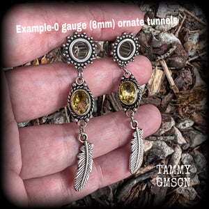 These beautiful boho tunnel earrings feature gorgeous antique silver feathers dangling from sparkly yellow citrine gemstones, weighing approx 6 grams each and measure 6.5cms from tip to tip.
This pair has been made with 0 gauge (8mm) gauge ornate surgical steel screw fit tunnels.