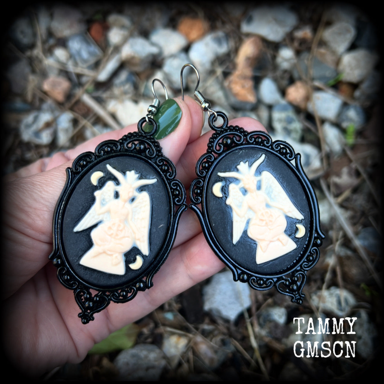 These gorgeous gothic earrings feature ivory Baphomets enclosed in beautiful black enamel framea, are light weight (11 grams a piece) and nice and dangly, measuring just over 8cms from tip to tip.

This pair has been made on stainless steel french hooks, suitable for pierced ears.

