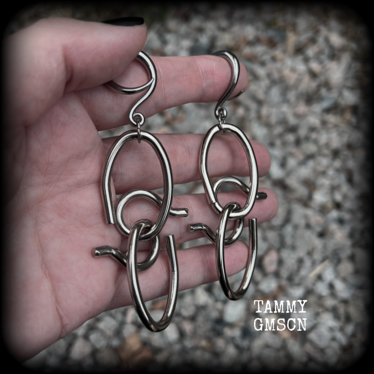 These awesome gauged earrings feature twisted and knotted surgical steel pieces, weighing approx 18 grams a piece, and nice and dangly at just over 9cms from tip to tip.

This pair has been made on 6 gauge (4mm) surgical steel full curl hooks, suitable for stretched lobes.