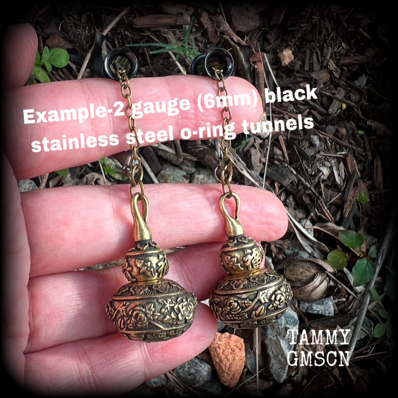 These brass stash pot tunnel dangles are gorgous! 
Featuring tibetan sanscrit and beautiful rose details, these earrings weigh in at approx 17 grams each, and nice and dangly, measuring in at just over 7cm from tip to tip.

These open up (as shown) so you can stash spell affirmations, drugs, precious pet ashes, anything you like really...

💥This listing includes one pair of surgical steel single flared O-ring earlets