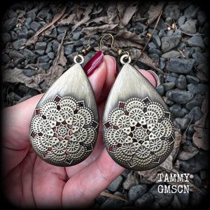 These beautiful teardrop earrings feature an intricate antique bronze mandala, are nice and light weight, weighing 6 grams each, and measuring just on 7 cms from tip to tip.
This pair have been made with antique french hooks, suitable for pierced ears.