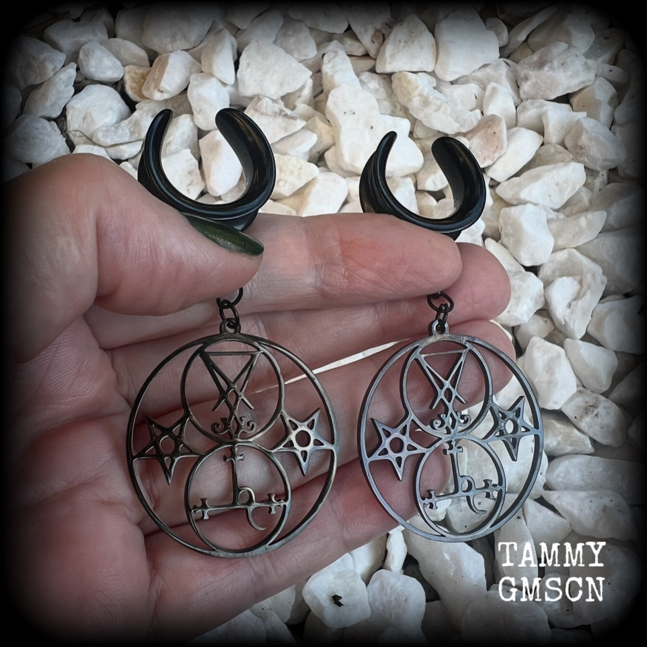 These gorgeous stainless steel earrings feature the Sigil of Lilith with the Sigil of Lucifer flanked by inverted pentagrams on each side. These earrings are lovely and light weight, weighing approx 9 grams each, and measure just on 7.5 cms from tip to tip.

This pair has been made on 3/4” gauge (19mm) surgical steel cradle hooks, to be worn in stretched lobes.
