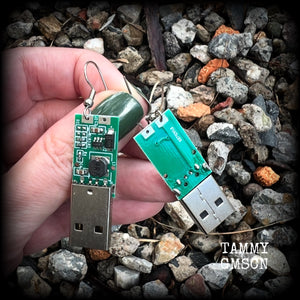 These awesome cyberpunk earrings feature a classic green USB, are nice and dangly, measuring just under 6cms from tip to tip, and nice and light weight, weighing only a few grams each.

This pair has been made on stainless steel french hooks, to be worn in pierced ears.