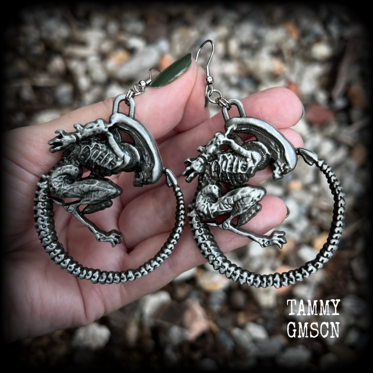This pair of awesome earrings features large Alien Queen Xenomorphs, measuring 8.5cms from tip to tip (nice and big), and weigh 35 grams each (these are HEAVY).

This pair have been made with stainless steel french hooks-suitable for pierced ears.
