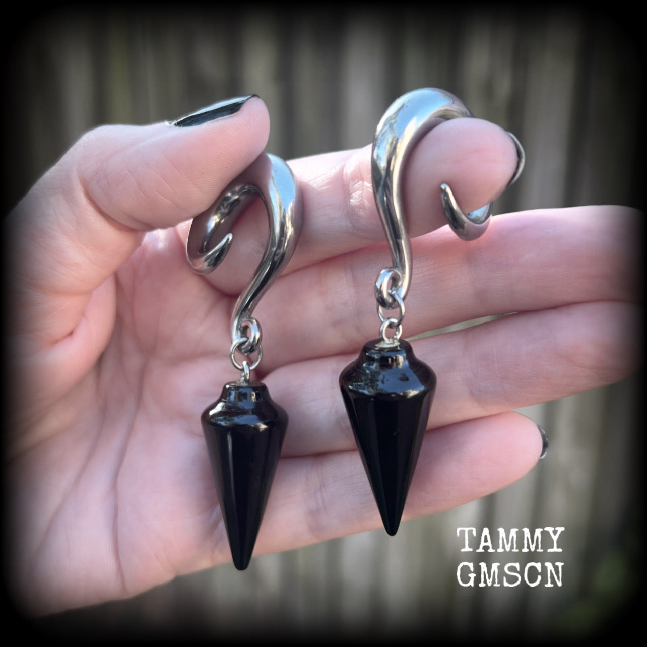 These earrings have been made with gorgeous pitch black obsidian pendulums, measuring 7.5cms from tip to tip, and weighing approx 22 grams each.

This pair have been made with 00 gauge (10mm) surgical steel full curl hooks, to be worn in stretched lobes.