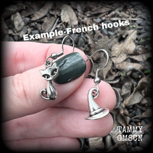 These adorably witchy earrings feature a cute antique silver black cat and witches hat! These earrings are nice and light weight at only a gram or two each, measuring just under 4cms from tip to tip.

This pair has been made on stainless steel french hooks, suitable for pierced ears.