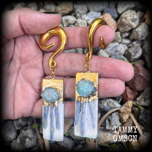 These unique gauged earrings feature selenite with ocean green druzy and sky blue kyanite, measuring approx 10cms from tip to tip, and weighing approx 25 grams each.

This pair have been made on 0 gauge (8mm) surgical steel full curl hooks, to be worn in stretched lobes.