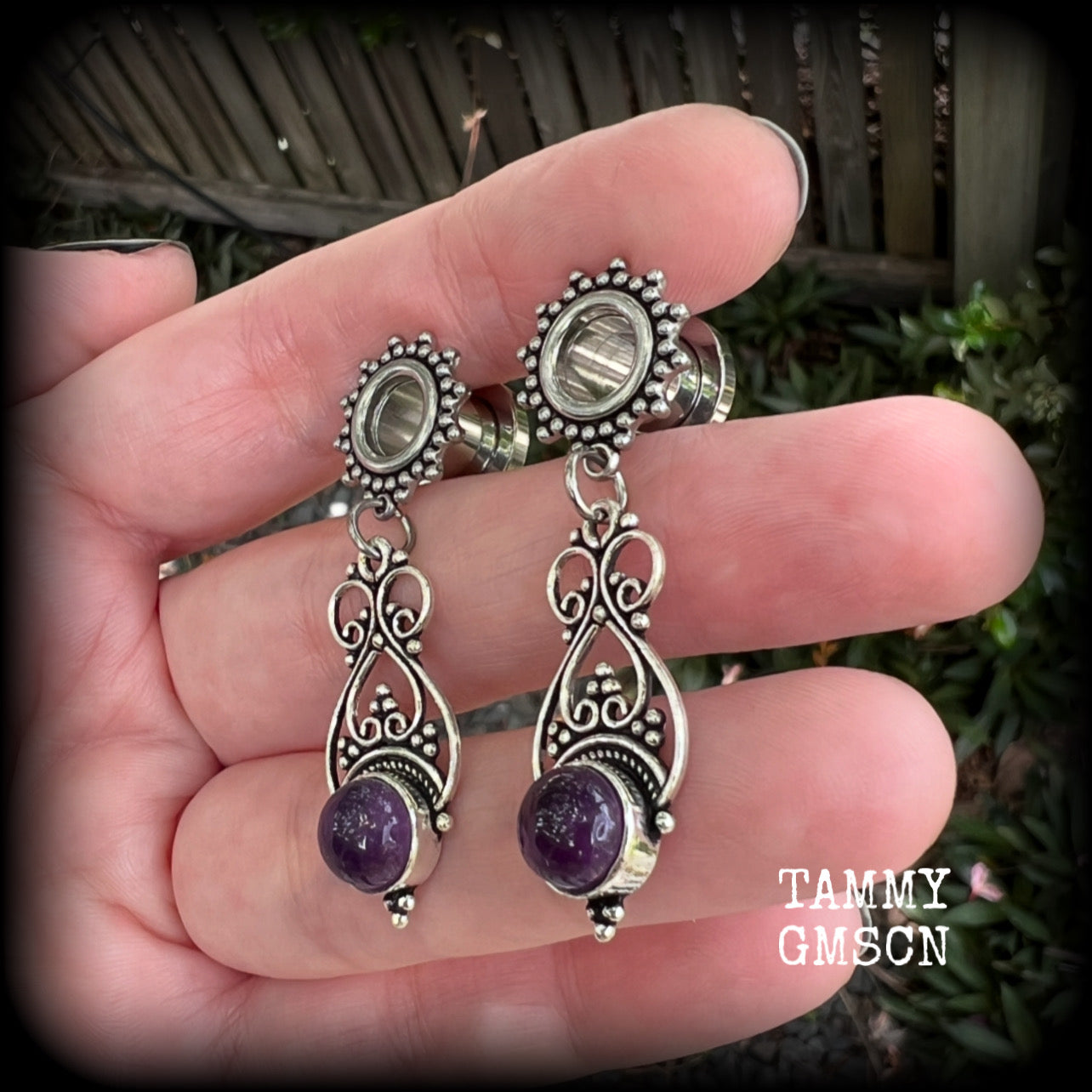 These beautiful boho tunnel earrings feature gorgeous polished amethyst gemstones, weighing approx 5 grams each and measure just under 5cms from tip to tip.

This pair has been made with 0 gauge (8mm) ornate surgical steel screw fit tunnels.
