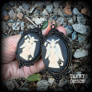 These gorgeous gothic earrings feature ivory Baphomets enclosed in beautiful black enamel framea, are light weight (11 grams a piece) and nice and dangly, measuring just over 8cms from tip to tip.

This pair has been made on stainless steel french hooks, suitable for pierced ears.

