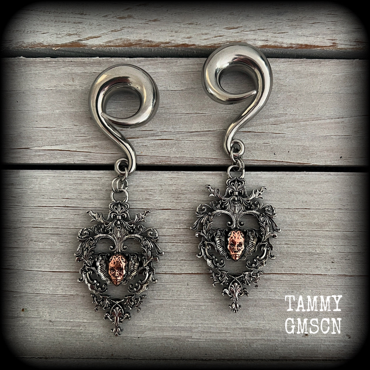 These gorgeous gauged earrings feature the face of a lost soul trapped within the bounds of beautiful baroque antique silver frames, measuring just under 9cms from tip to tip, and weighing approx 33 grams each.

This pair has been made on 00 gauge (10mm) surgical steel full curls, to be worn in stretched lobes.