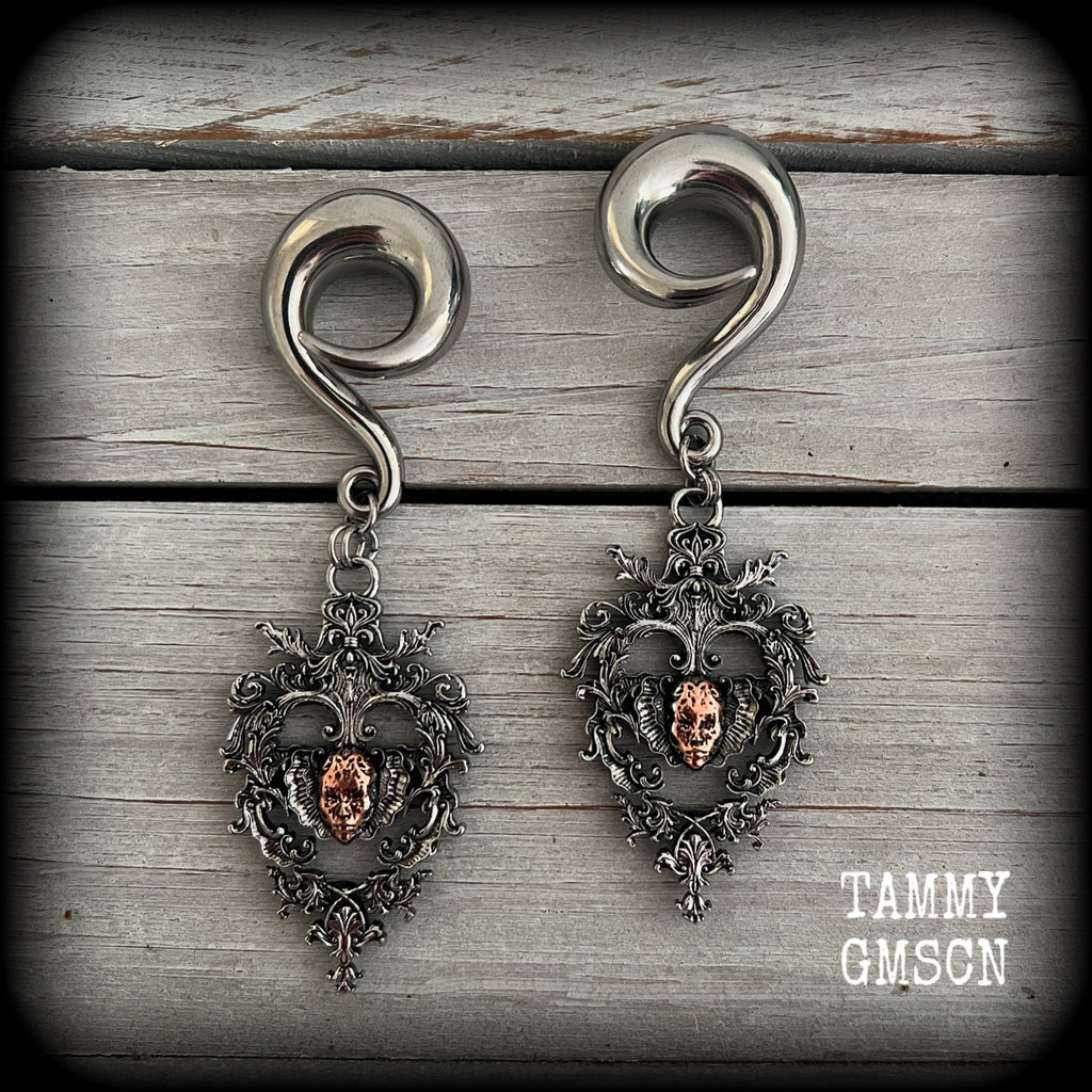 These gorgeous gauged earrings feature the face of a lost soul trapped within the bounds of beautiful baroque antique silver frames, measuring just under 9cms from tip to tip, and weighing approx 33 grams each.

This pair has been made on 00 gauge (10mm) surgical steel full curls, to be worn in stretched lobes.