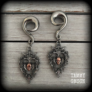These gorgeous gauged earrings feature the face of a lost soul trapped within the bounds of beautiful baroque antique silver frames, measuring just under 9cms from tip to tip, and weighing approx 33 grams each.

This pair has been made on 00 gauge (10mm) surgical steel full curls, to be worn in stretched lobes.