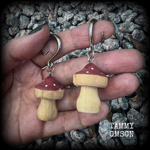 This pair of earrings features gorgeous dusty pink wood mushrooms, nice and light weight at 7 grams a piece, and nice and dangly at just on 6.5cms from tip to tip.

This pair has been made on 6 gauge (4mm) surgical steel full curl hooks, suitable for stretched lobes.