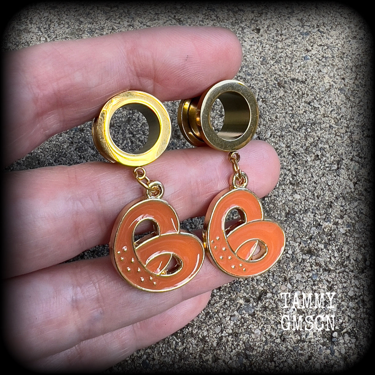 These adorable tunnel earrings feature classic enamel and antique gold pretzel charms, weighing approx 5 grams each, and measuring just over 4 cms from tip to tip.

This pair has been made with 1/2” gauge (12mm) surgical steel screw fit tunnels, to be worn in stretched lobes.