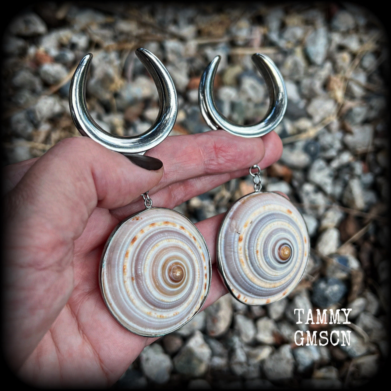 These gauged earrings feature beautiful big Giant sundail sea snail shells weighing in at 25 grams a piece, and nice and dangly at just over 10cms from tip to tip. 
This pair has been made on 1.18” gauge (30mm) surgical steel cradles