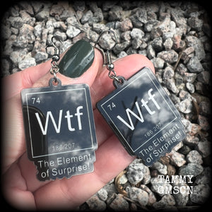 This cheeky pair of earrings features acrylic letter tiles showing the chemical element of Wtf, the Element of Surprise!!!
Measuring just over 6cms from tip to tip, these earrings weigh only a few grams each.

This pair has been made with stainless steel french hooks, suitable for pierced ears.