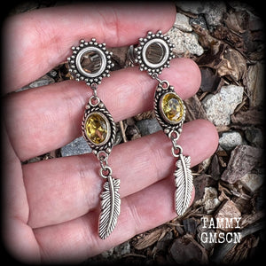 These beautiful boho tunnel earrings feature gorgeous antique silver feathers dangling from sparkly yellow citrine gemstones, weighing approx 6 grams each and measure 6.5cms from tip to tip.
This pair has been made with 0 gauge (8mm) gauge ornate surgical steel screw fit tunnels.