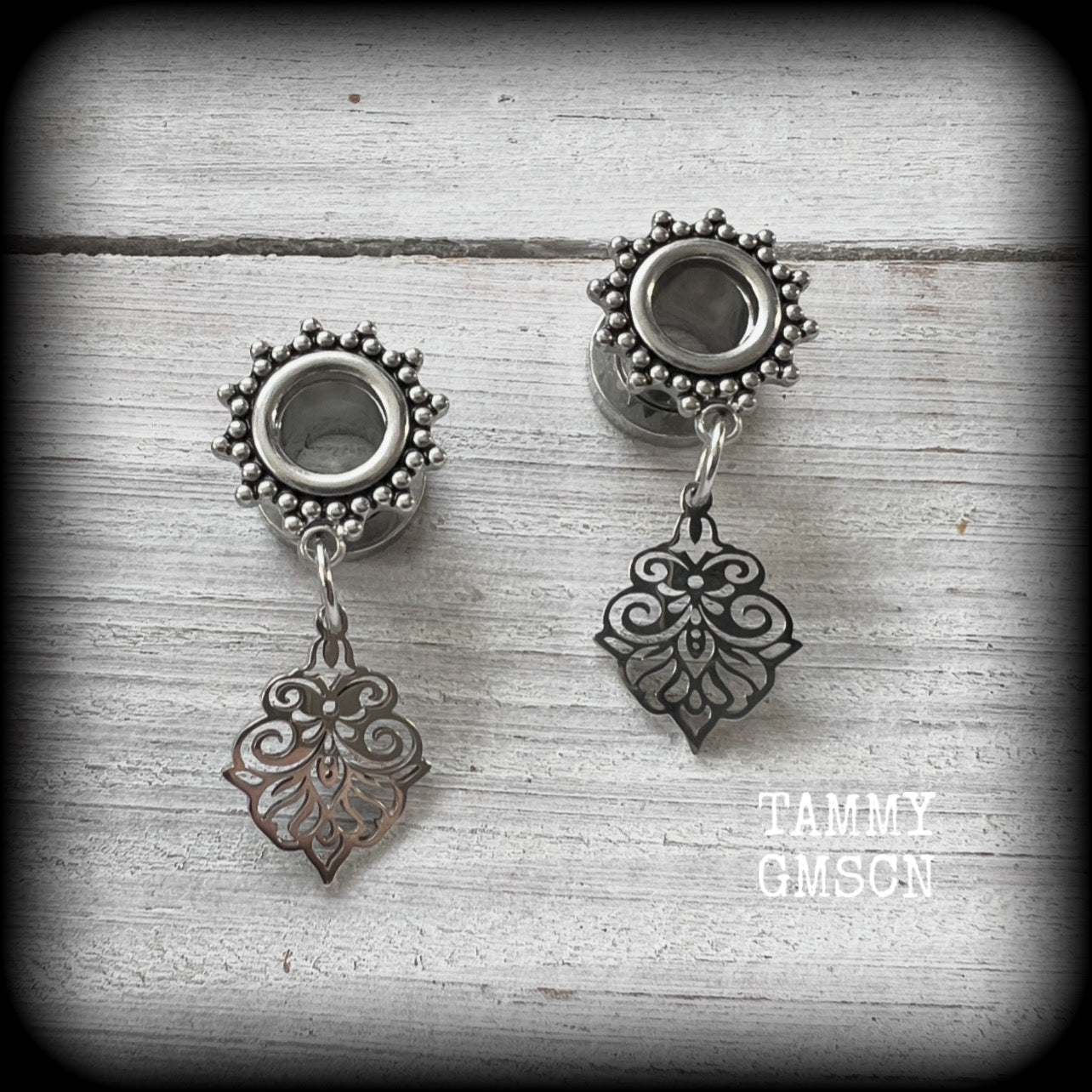 These beautiful ornate tunnel earrings feature gorgeous stainless steel filigree charms, inspired by Aphrodite, the Greek Goddess of love and beauty.

These earrings are nice and lightweight, weighing only a few grams each and measure just under 4cms from tip to tip.

This pair has been made with 0 gauge (8mm) gauge ornate surgical steel screw fit tunnels.