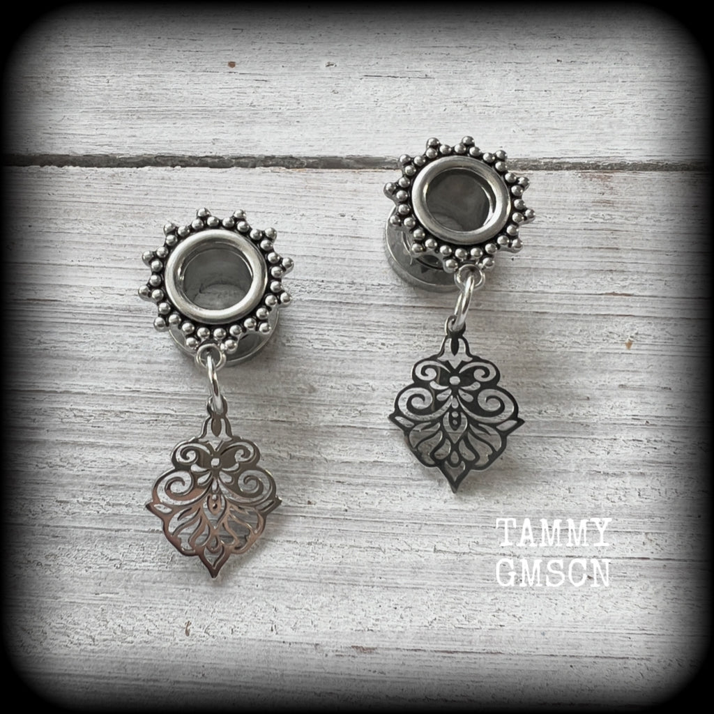 These beautiful ornate tunnel earrings feature gorgeous stainless steel filigree charms, inspired by Aphrodite, the Greek Goddess of love and beauty.

These earrings are nice and lightweight, weighing only a few grams each and measure just under 4cms from tip to tip.

This pair has been made with 0 gauge (8mm) gauge ornate surgical steel screw fit tunnels.