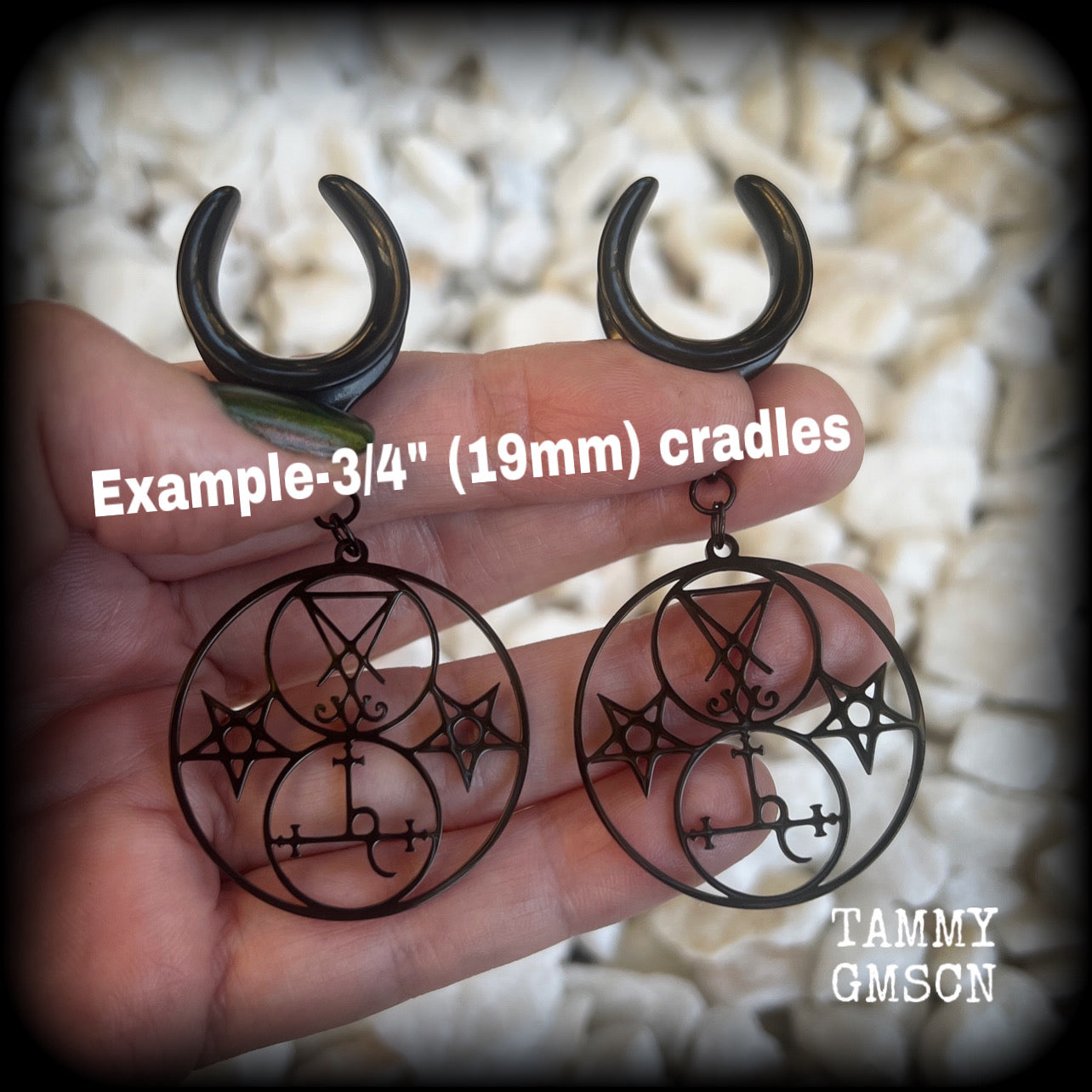 These gorgeous stainless steel earrings feature the Sigil of Lilith with the Sigil of Lucifer flanked by inverted pentagrams on each side. These earrings are lovely and light weight, weighing approx 9 grams each, and measure just on 7.5 cms from tip to tip.

This pair has been made on 3/4” gauge (19mm) surgical steel cradle hooks, to be worn in stretched lobes.
