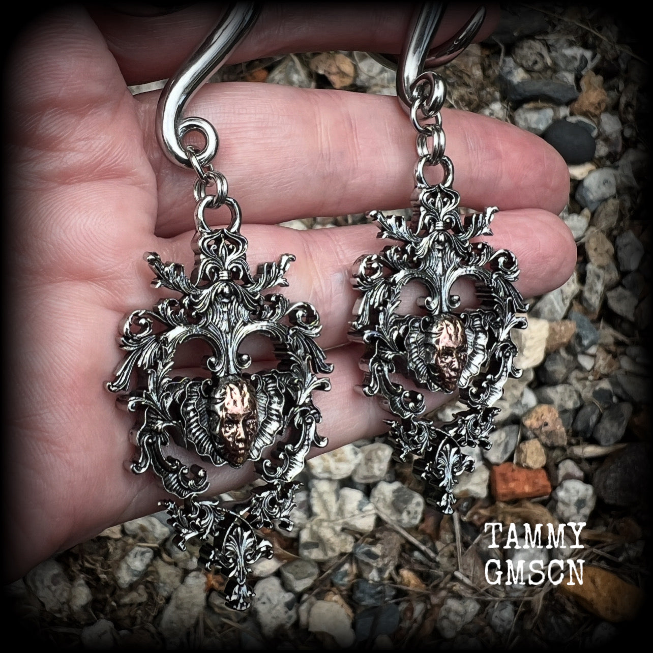 These gorgeous gauged earrings feature the face of a lost soul trapped within the bounds of beautiful baroque antique silver frames, measuring just under 9cms from tip to tip, and weighing approx 33 grams each.

This pair has been made on 00 gauge (10mm) surgical steel full curls, to be worn in stretched lobes.