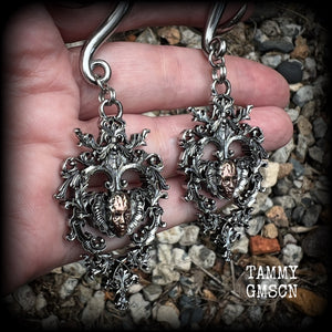 These gorgeous gauged earrings feature the face of a lost soul trapped within the bounds of beautiful baroque antique silver frames, measuring just under 9cms from tip to tip, and weighing approx 33 grams each.

This pair has been made on 00 gauge (10mm) surgical steel full curls, to be worn in stretched lobes.