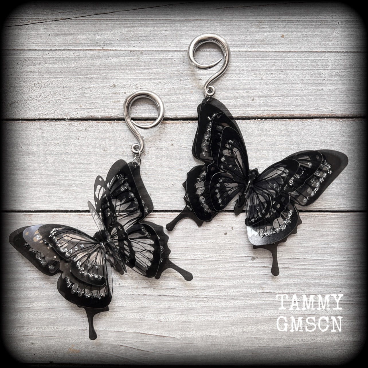 These gorgeous gauged glittery earrings feature beautiful big swallowtail butterflies, super lightweight at just 5 grams a piece, measuring 11cms from tip to tip.

This pair have been made on 6 gauge (4mm) surgical steel full curls, to be worn through stretched lobes.