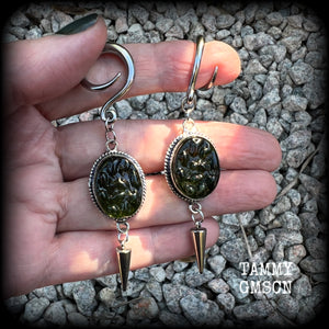 This pair of earrings features gorgeous forest green moldavite gemstones in a boho antique silver setting, weighing approx 10 grams a piece and measuring just on 8cms from tip to tip.  This pair have been made on 6 gauge (4mm) surgical steel full curl hooks, to be worn in stretched lobes.