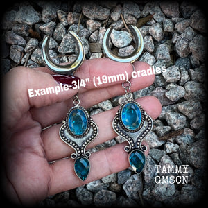 These earrings feature gorgeous facet blue topaz gemstones in a beautiful boho antique silver setting, lovely and dangly at just on 8cms from tip to tip, and not too heavy at 12 grams each.

These earrings have been made on 3/4” gauge (19mm) surgical steel cradles, to be worn in stretched lobes.