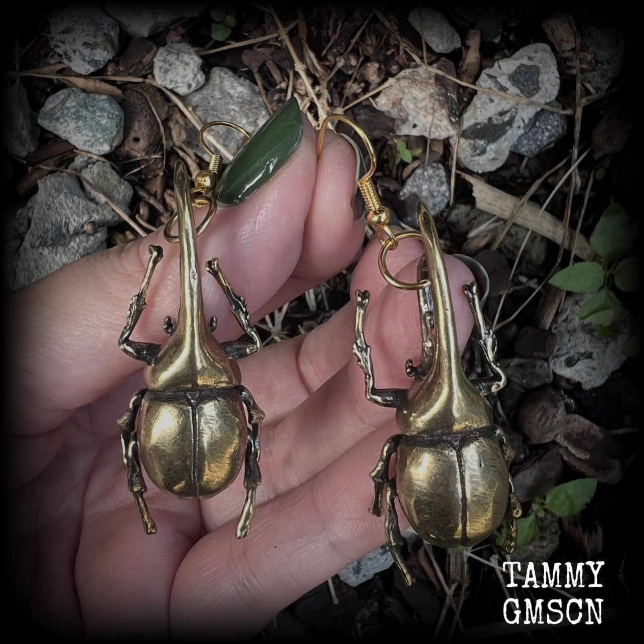 These gorgeous brass Hercules beetle earrings are big and beautiful! Weighing approx 19 grams each, this pair measures 7cms from tip to tip.

This pair has been made on antique gold french hooks, suitable for pierced ears.