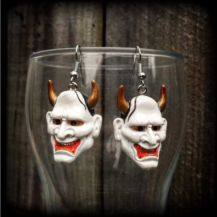 Featuring traditional red white and gold carved wood hannya mask charms, these unique earrings measure just on 6cms from tip to tip, and weigh only 5 grams each.

This pair have been made with stainless steel french hooks, for pierced ears.