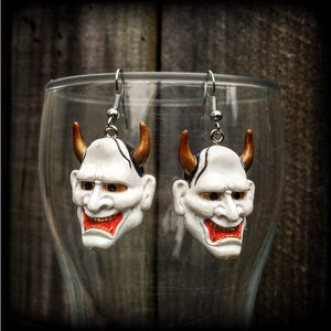 Featuring traditional red white and gold carved wood hannya mask charms, these unique earrings measure just on 6cms from tip to tip, and weigh only 5 grams each.

This pair have been made with stainless steel french hooks, for pierced ears.
