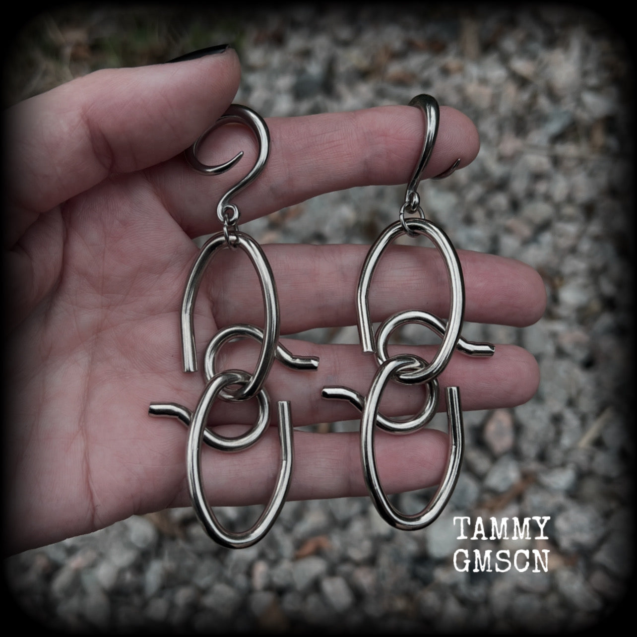 These awesome gauged earrings feature twisted and knotted surgical steel pieces, weighing approx 18 grams a piece, and nice and dangly at just over 9cms from tip to tip.

This pair has been made on 6 gauge (4mm) surgical steel full curl hooks, suitable for stretched lobes.