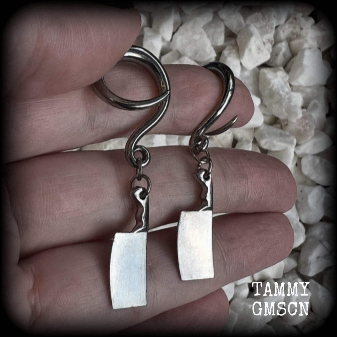 Featuring a pair of awesome antique silver meat cleavers, these earrings are super lightweight, weighing in at only 5 grams a piece, and are nice and dangly at just on 5.5cms.

🩸 Do you want a bit of b l o o d on your meat cleavers? Please just let us know!

This pair has been made on 6 gauge (4mm) surgical steel full curl hooks, to be worn in stretched lobes.