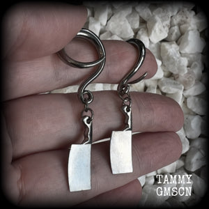 Featuring a pair of awesome antique silver meat cleavers, these earrings are super lightweight, weighing in at only 5 grams a piece, and are nice and dangly at just on 5.5cms.

🩸 Do you want a bit of b l o o d on your meat cleavers? Please just let us know!

This pair has been made on 6 gauge (4mm) surgical steel full curl hooks, to be worn in stretched lobes.